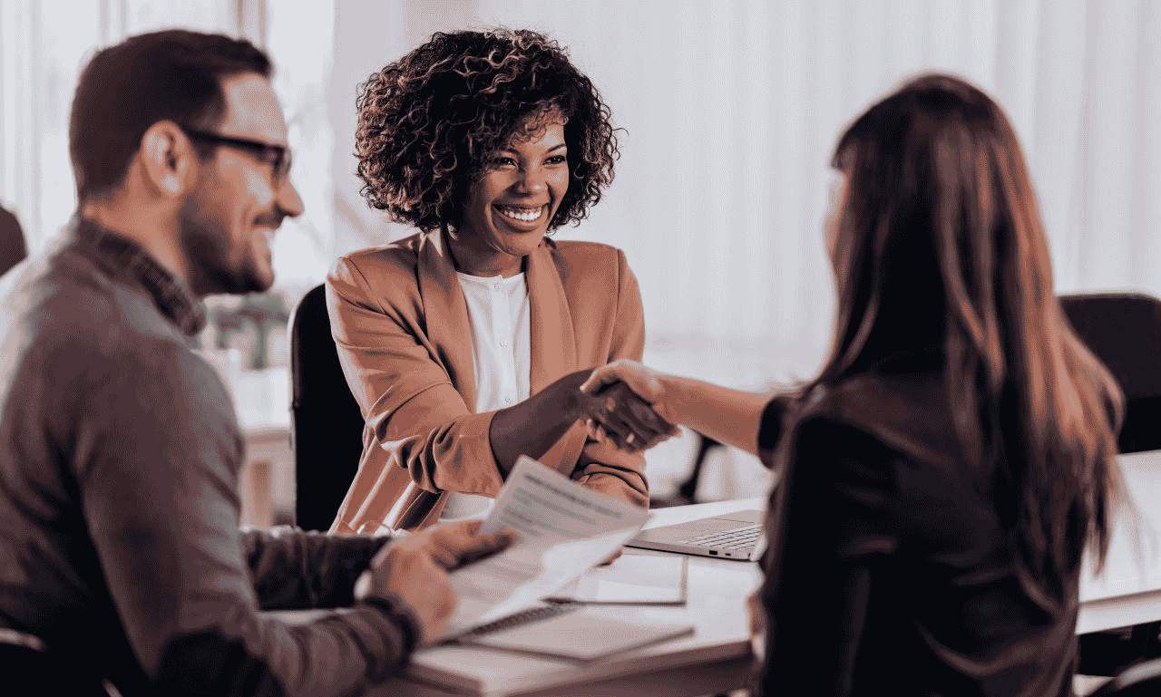 Professional meeting with people shaking hands during a business discussion, representing success, teamwork, and new opportunities.